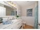 Bathroom with a white vanity, wood floors, beadboard, and a window for natural light at 1235 Willowick Cir, Safety Harbor, FL 34695