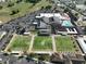 Aerial view of community center showcasing lawn bowling, a pool, and parking at 1509 Blackstone Cir, Sun City Center, FL 33573