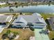 An aerial view showcases a beautiful home, its manicured landscaping, and the serene lake it overlooks at 1509 Blackstone Cir, Sun City Center, FL 33573