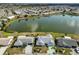 Scenic aerial of waterfront community, featuring homes nestled along a tranquil lake at 1509 Blackstone Cir, Sun City Center, FL 33573