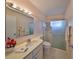 Bathroom featuring vanity with light, mirror, and shower with glass door at 1509 Blackstone Cir, Sun City Center, FL 33573