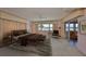 Cozy bedroom featuring a ceiling fan, and a sliding glass door with water views at 1509 Blackstone Cir, Sun City Center, FL 33573