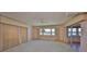Bright bedroom featuring a ceiling fan, and a sliding glass door with water views at 1509 Blackstone Cir, Sun City Center, FL 33573