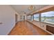 Bright Florida room features parquet floors, large windows with lake view, and ceiling fan at 1509 Blackstone Cir, Sun City Center, FL 33573