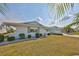 Charming white brick home features a well-manicured lawn and delightful landscaping at 1509 Blackstone Cir, Sun City Center, FL 33573