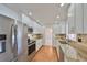 Modern kitchen featuring stainless steel appliances, granite countertops, and white cabinetry at 1509 Blackstone Cir, Sun City Center, FL 33573