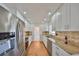 Modern kitchen featuring stainless steel appliances, granite countertops, and white cabinetry at 1509 Blackstone Cir, Sun City Center, FL 33573
