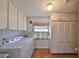 Laundry room with washer, dryer, cabinets, and closet at 1509 Blackstone Cir, Sun City Center, FL 33573