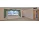 Inviting living room features large window with elegant curtains and neutral carpet at 1509 Blackstone Cir, Sun City Center, FL 33573