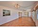 Bright living room featuring hardwood floors, a decorative chandelier, and abundant natural light at 1509 Blackstone Cir, Sun City Center, FL 33573