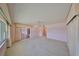 Large living room with a ceiling fan and sliding glass doors leading to another room at 1509 Blackstone Cir, Sun City Center, FL 33573