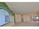 Bright living room with neutral walls and carpet, featuring a large window and doorways at 1509 Blackstone Cir, Sun City Center, FL 33573