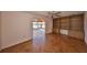 Inviting living room showcases hardwood floors, ceiling fan and a built-in wooden bookcase at 1509 Blackstone Cir, Sun City Center, FL 33573