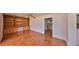 Bright living room featuring hardwood floors, ceiling fan and a built-in wooden bookcase at 1509 Blackstone Cir, Sun City Center, FL 33573