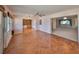 Spacious room features a ceiling fan and herringbone wood flooring at 1509 Blackstone Cir, Sun City Center, FL 33573