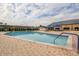 Outdoor pool with brick surround, lounge chairs, and umbrellas against a sunny sky at 1509 Blackstone Cir, Sun City Center, FL 33573