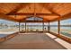 Spacious sunroom with a high wood ceiling and walls of windows offering serene views of the lake at 1509 Blackstone Cir, Sun City Center, FL 33573