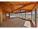 Bright sunroom with a wood paneled ceiling and floor-to-ceiling windows showcasing water views at 1509 Blackstone Cir, Sun City Center, FL 33573