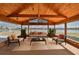 Inviting sunroom features wood ceiling and large windows with beautiful water views; perfect for relaxation at 1509 Blackstone Cir, Sun City Center, FL 33573