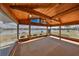 Bright sunroom with a wood paneled ceiling and floor-to-ceiling windows showcasing water views at 1509 Blackstone Cir, Sun City Center, FL 33573