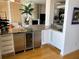 Wet bar with granite countertops, wine cooler, and stainless steel refrigerator at 1522 Gulf Blvd, Indian Rocks Beach, FL 33785