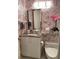 Stylish bathroom featuring pink shoe-themed wallpaper, sleek vanity, and modern fixtures for a chic design at 1522 Gulf Blvd, Indian Rocks Beach, FL 33785