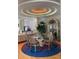 Dining area features a glass table, decorative chairs, a custom ceiling, and stylish decor at 1522 Gulf Blvd, Indian Rocks Beach, FL 33785
