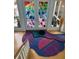 A modern entryway with wood floors and an artistic stained glass door at 1522 Gulf Blvd, Indian Rocks Beach, FL 33785