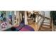 Bright foyer with artistic rug, wood stairs, and artistic stained glass door at 1522 Gulf Blvd, Indian Rocks Beach, FL 33785