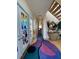 Bright foyer with artistic rug, wood stairs, and stained glass door at 1522 Gulf Blvd, Indian Rocks Beach, FL 33785