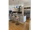 Modern kitchen featuring a breakfast bar, stainless steel appliances, and stylish light fixtures at 1522 Gulf Blvd, Indian Rocks Beach, FL 33785