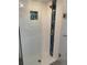 Modern walk-in shower features white textured walls, a blue accent strip, and a glass door at 1522 Gulf Blvd, Indian Rocks Beach, FL 33785