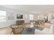 Bright living room with modern furniture, neutral decor, wood floors, and ample natural light at 17259 Whiskey Creek Trl, Parrish, FL 34219