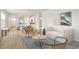 Open-concept living area featuring contemporary decor, wood floors, and an open view into the kitchen at 17259 Whiskey Creek Trl, Parrish, FL 34219