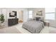 Serene bedroom with a queen-sized bed, neutral colors, and modern decor at 17259 Whiskey Creek Trl, Parrish, FL 34219