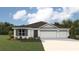 Charming single-story home with three-car garage and manicured front yard at 17464 Whiskey Creek Trl, Parrish, FL 34219