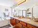 Bathroom features a dual vanity with wood cabinets and a soaking tub shower combo at 1805 Abbey Trace Dr, Dover, FL 33527