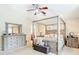 Bedroom with a four poster bed and dresser with light-colored walls and a ceiling fan at 1805 Abbey Trace Dr, Dover, FL 33527