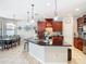 Spacious kitchen featuring a large island, granite countertops, and modern appliances at 1805 Abbey Trace Dr, Dover, FL 33527