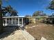 Backyard with partial view of the house and enclosed porch at 1817 Meridel Ave, Tampa, FL 33612