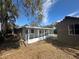 Rear of house showing the enclosed back porch and the yard at 1817 Meridel Ave, Tampa, FL 33612