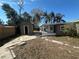 Backyard with a storage shed, enclosed porch, and partial view of the home's exterior at 1817 Meridel Ave, Tampa, FL 33612