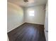 Bright bedroom offers dark wood floors and closet at 1817 Meridel Ave, Tampa, FL 33612