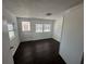 Bright bedroom featuring dark wood-look floors and a door leading to the outside at 1817 Meridel Ave, Tampa, FL 33612