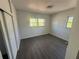 Bright bedroom with two windows and closet, showcasing the neutral paint and modern flooring at 1817 Meridel Ave, Tampa, FL 33612