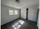 Well-lit bedroom with closet featuring wood-look flooring and a window view at 1817 Meridel Ave, Tampa, FL 33612