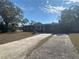 Street view of single-story house, long driveway, and a well-maintained lawn in the front at 1817 Meridel Ave, Tampa, FL 33612