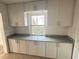 Updated kitchen featuring granite countertops, and white cabinetry at 1817 Meridel Ave, Tampa, FL 33612