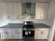 New stainless steel appliances, granite countertops, and bright white cabinets at 1817 Meridel Ave, Tampa, FL 33612