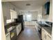 Updated kitchen featuring stainless steel appliances, granite countertops, and white cabinetry at 1817 Meridel Ave, Tampa, FL 33612